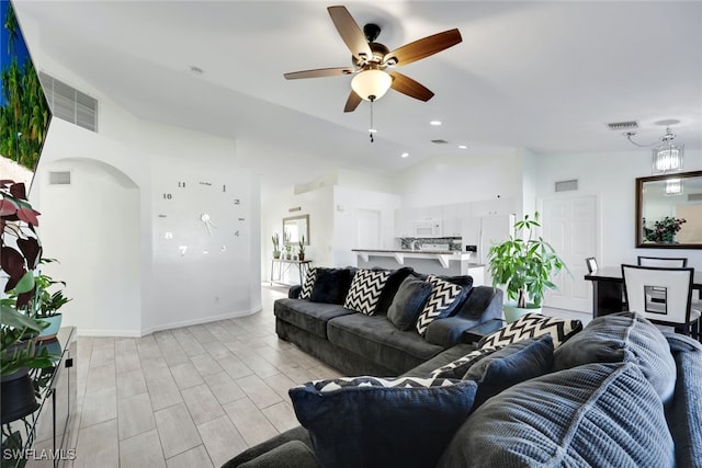 living room with vaulted ceiling, ceiling fan, and light wood-type flooring