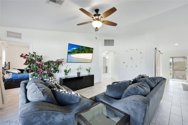 living room featuring ceiling fan and lofted ceiling