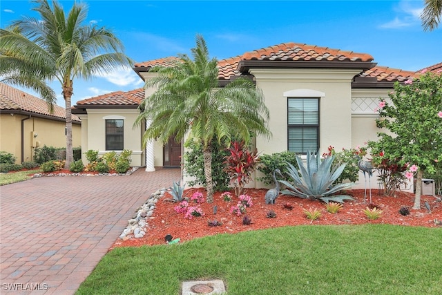 mediterranean / spanish-style home with a front yard