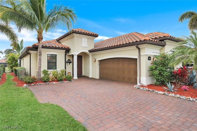 mediterranean / spanish house featuring a garage