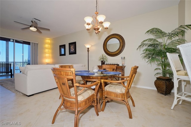 tiled dining space with ceiling fan with notable chandelier