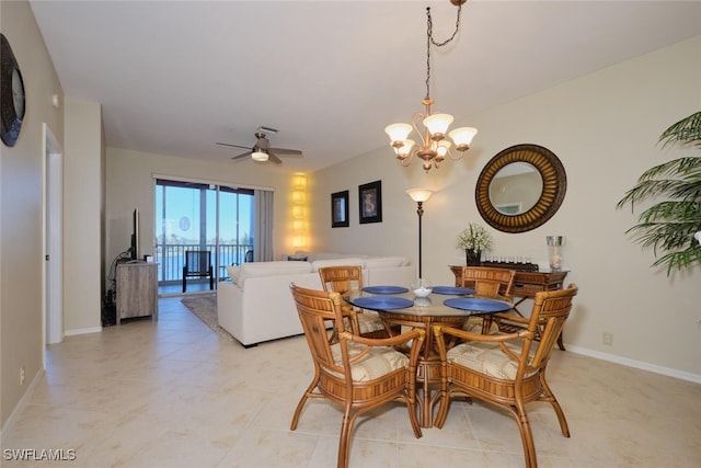 tiled dining room featuring ceiling fan with notable chandelier