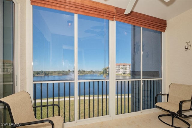 sunroom / solarium featuring a water view