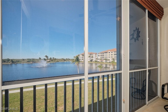 unfurnished sunroom featuring a water view