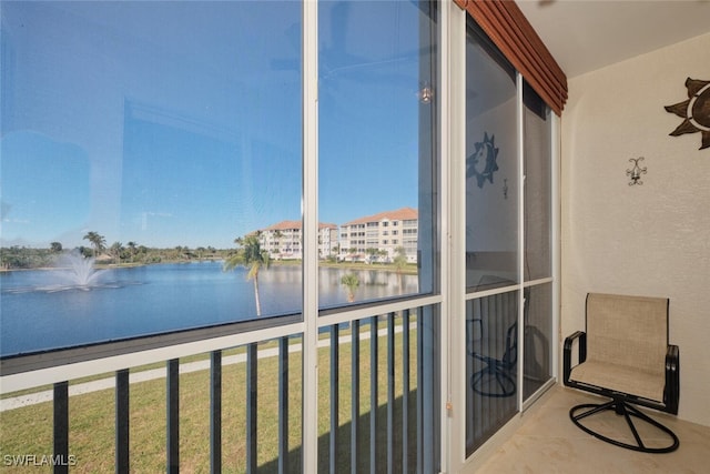 unfurnished sunroom featuring a water view