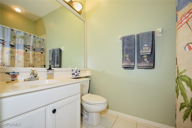 bathroom featuring toilet, tile patterned floors, and vanity