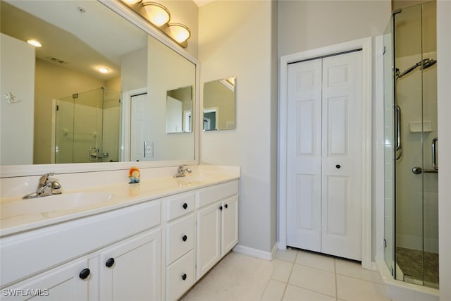 bathroom featuring tile patterned floors, vanity, and an enclosed shower