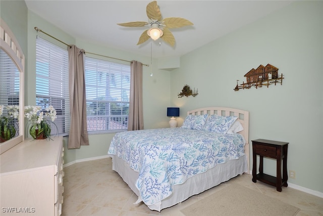 tiled bedroom featuring ceiling fan