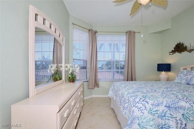 tiled bedroom featuring ceiling fan