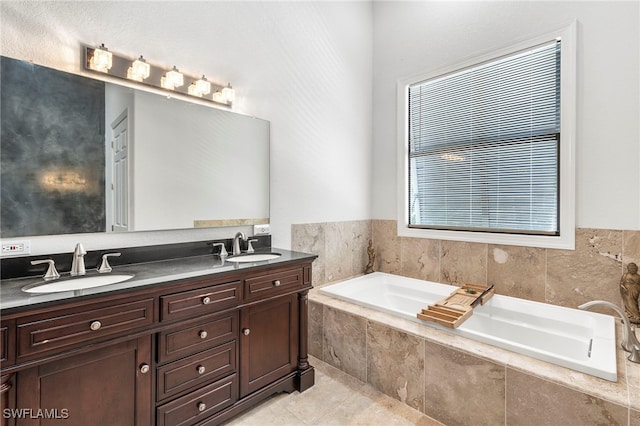 bathroom featuring tiled bath and vanity