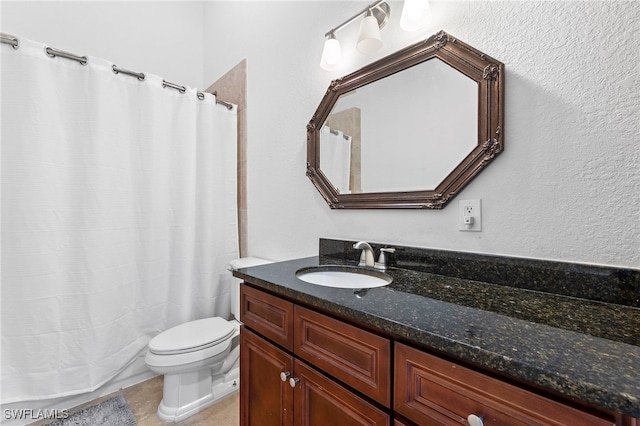 bathroom with toilet and vanity