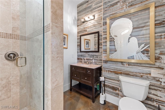 bathroom with toilet, a shower with shower door, and vanity