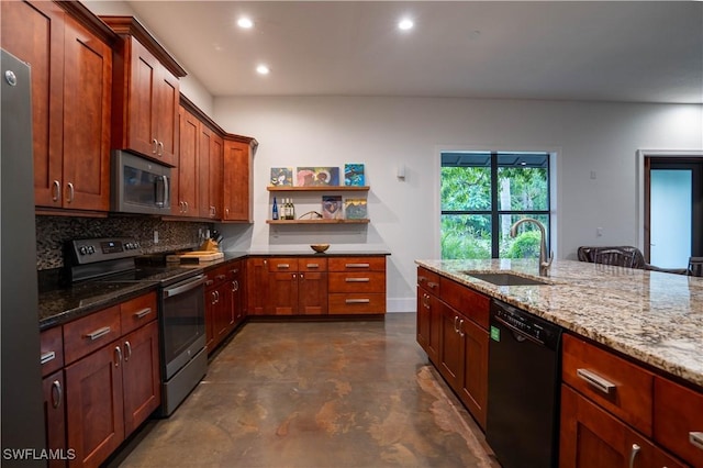 kitchen with light stone countertops, appliances with stainless steel finishes, decorative backsplash, and sink