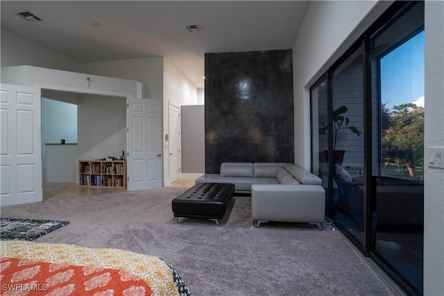 bedroom with access to exterior, vaulted ceiling, and carpet flooring