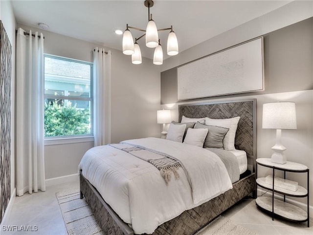 bedroom featuring light tile patterned flooring and an inviting chandelier