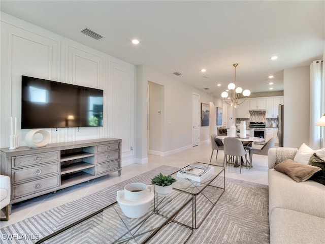 tiled living room with an inviting chandelier