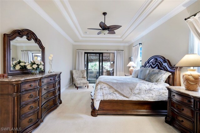 bedroom featuring access to exterior, light carpet, ornamental molding, ceiling fan, and a tray ceiling