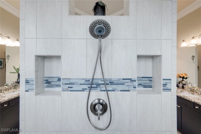 bathroom featuring crown molding, walk in shower, and vanity