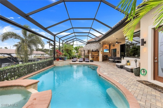 view of swimming pool with a lanai, a patio, and ceiling fan