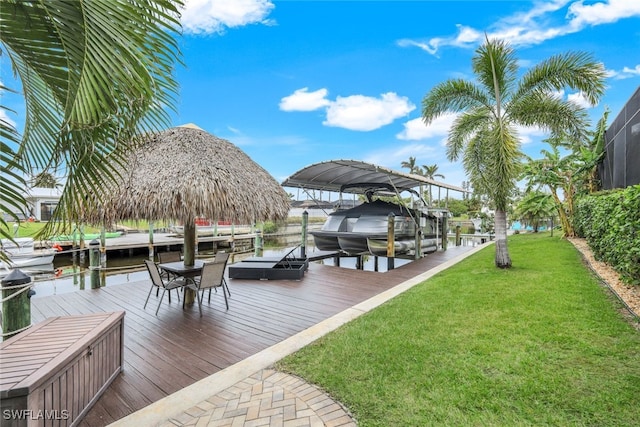 view of dock featuring a water view and a yard