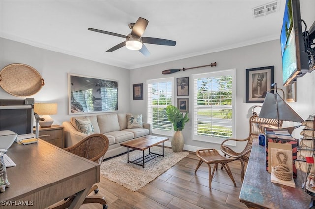 living room with ceiling fan and crown molding