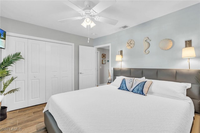 bedroom with ceiling fan and a closet