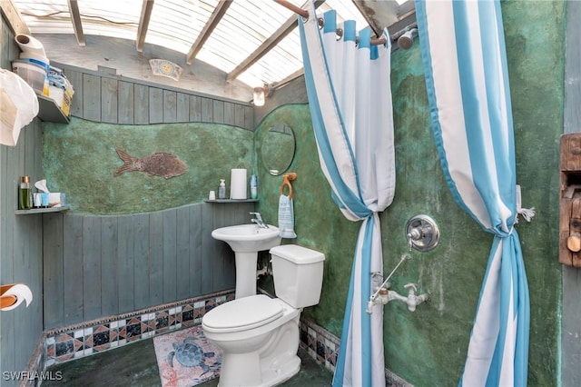 bathroom with toilet and wooden walls