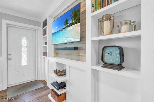 entrance foyer featuring wood-type flooring and crown molding