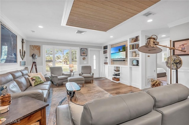 living room featuring built in features, ornamental molding, wood ceiling, and light wood-type flooring