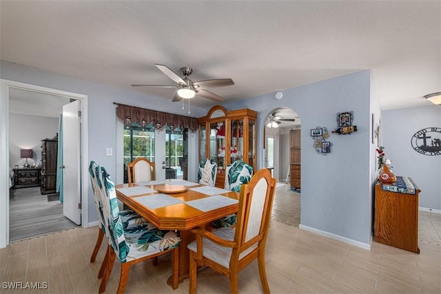 dining area featuring french doors, ceiling fan, and light hardwood / wood-style flooring