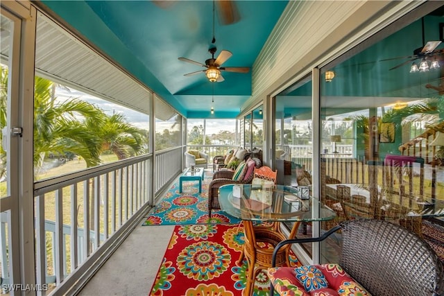 sunroom featuring ceiling fan and lofted ceiling