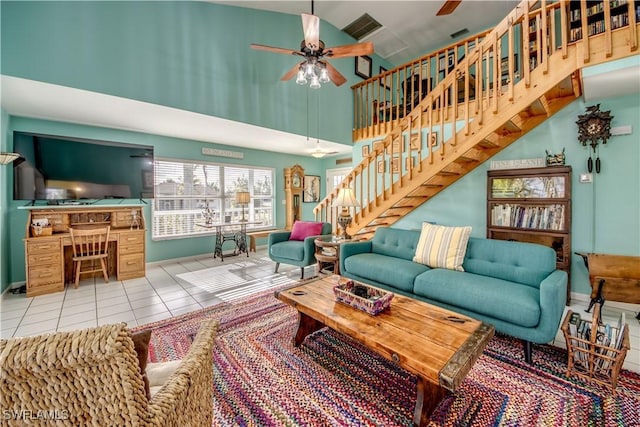 tiled living room featuring ceiling fan and high vaulted ceiling