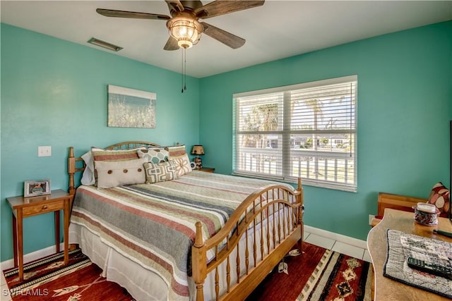 tiled bedroom with ceiling fan