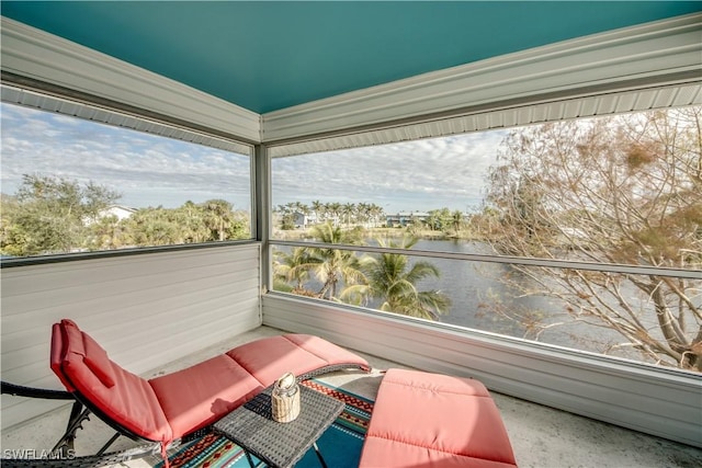 unfurnished sunroom with a water view