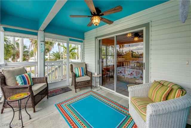 sunroom / solarium featuring ceiling fan