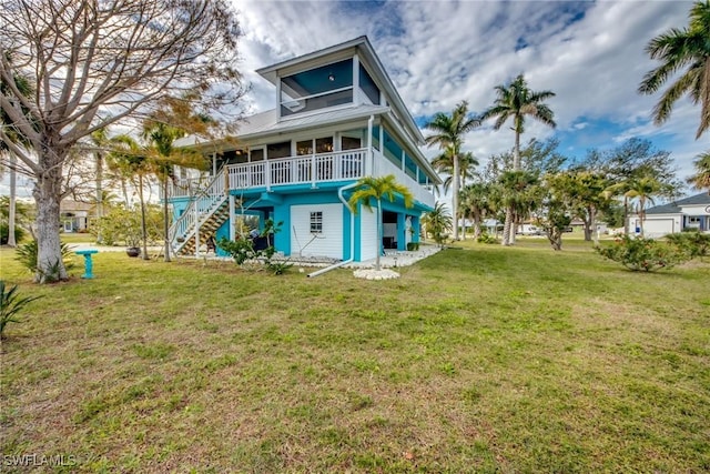 back of house featuring a yard and a porch