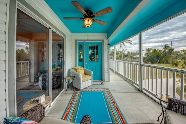 sunroom / solarium featuring ceiling fan