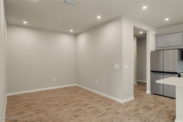 unfurnished room featuring light hardwood / wood-style floors