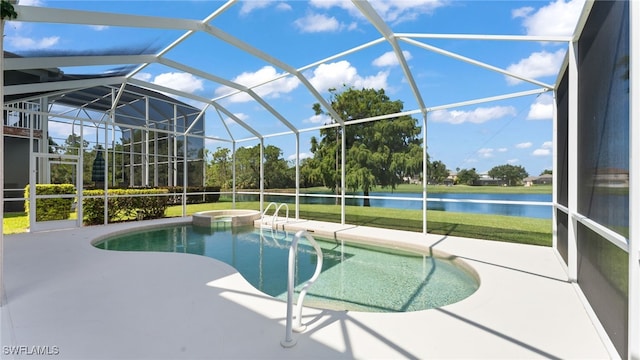 view of pool featuring glass enclosure, an in ground hot tub, a water view, a patio, and a lawn