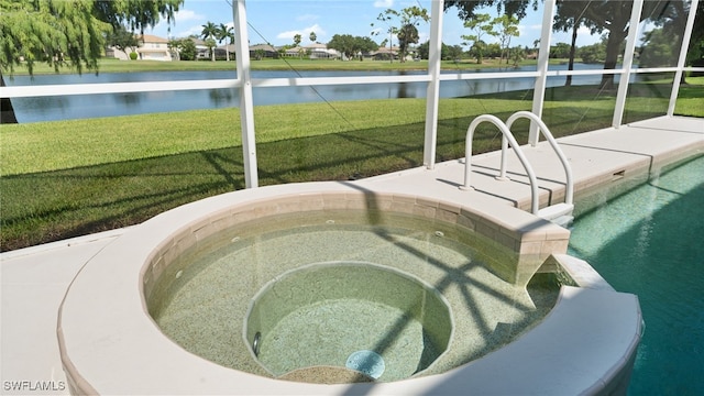 exterior space with an in ground hot tub, a yard, and a water view