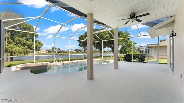 view of swimming pool featuring glass enclosure, a water view, an in ground hot tub, and a patio