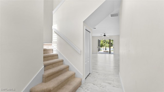 stairway with ceiling fan