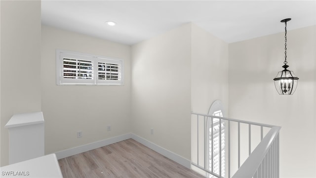 empty room featuring light hardwood / wood-style floors and an inviting chandelier