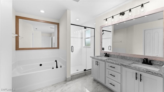 bathroom featuring separate shower and tub and vanity