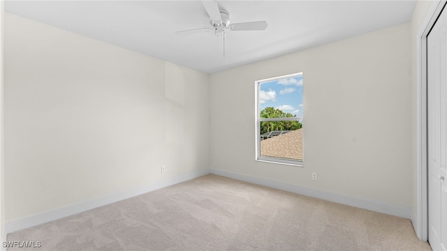 carpeted empty room featuring ceiling fan