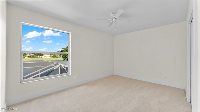 carpeted empty room featuring ceiling fan