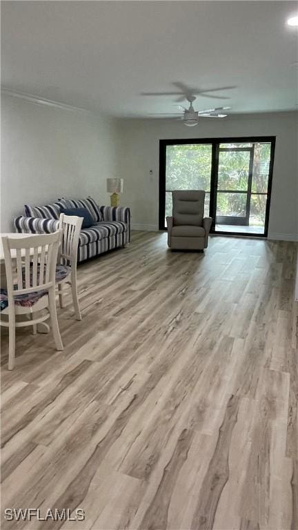 living room featuring ceiling fan and light wood-type flooring