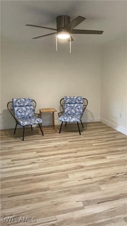 living area featuring ceiling fan and light hardwood / wood-style floors