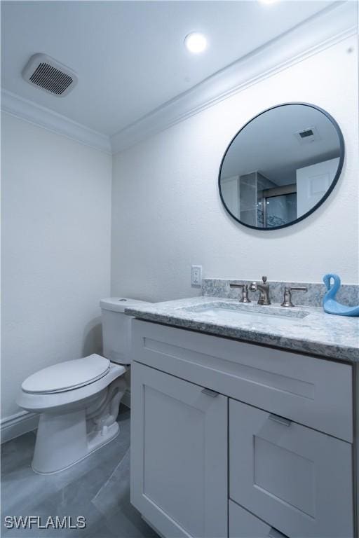 bathroom featuring vanity, crown molding, and toilet