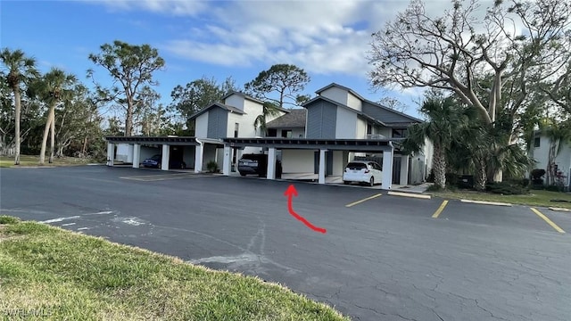 view of vehicle parking with a carport